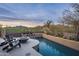 Inviting pool with a fire pit and mountain backdrop at 10598 E Fernwood Ln, Scottsdale, AZ 85262