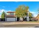 Two-story house with a white exterior, attached garage, and landscaping at 1126 E San Remo Ave, Gilbert, AZ 85234