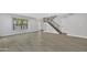 Living room with gray flooring and staircase with black railing at 1126 E San Remo Ave, Gilbert, AZ 85234