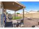 Backyard patio with fire pit and artificial turf at 11608 W Oglesby Ave, Youngtown, AZ 85363