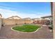 Backyard with artificial turf and fire pit at 11608 W Oglesby Ave, Youngtown, AZ 85363