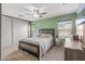 Well-lit bedroom with ceiling fan, double closets and wall-mounted TV at 11608 W Oglesby Ave, Youngtown, AZ 85363