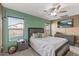 Comfortable bedroom with ceiling fan and view of backyard at 11608 W Oglesby Ave, Youngtown, AZ 85363