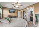 Spacious bedroom with a large bed, dresser, and ceiling fan at 11608 W Oglesby Ave, Youngtown, AZ 85363