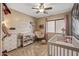 Adorable Bedroom featuring a crib, changing table, and rocker at 11608 W Oglesby Ave, Youngtown, AZ 85363