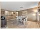 Bright dining room with white table and chairs, and decorative rug at 11608 W Oglesby Ave, Youngtown, AZ 85363