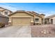 Tan house with a two-car garage and desert landscaping at 11608 W Oglesby Ave, Youngtown, AZ 85363