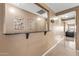 Clean hallway with a view of the living room and decorative wall at 11608 W Oglesby Ave, Youngtown, AZ 85363