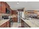 Spacious kitchen with granite countertops and stainless steel appliances at 11608 W Oglesby Ave, Youngtown, AZ 85363