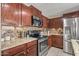 Modern kitchen featuring dark wood cabinets and granite countertops at 11608 W Oglesby Ave, Youngtown, AZ 85363