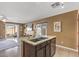 Kitchen with granite island, stainless steel appliances, and view into living room at 11608 W Oglesby Ave, Youngtown, AZ 85363