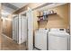 Laundry room with washer, dryer, and storage shelves at 11608 W Oglesby Ave, Youngtown, AZ 85363