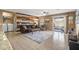 Living area with tile floors, a wood accent wall, and access to laundry at 11608 W Oglesby Ave, Youngtown, AZ 85363