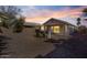 Backyard view at dusk with patio and gravel at 12838 N 148Th Ln, Surprise, AZ 85379