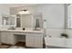 Modern bathroom featuring double sinks and a large mirror at 12838 N 148Th Ln, Surprise, AZ 85379