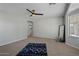 Bedroom with ceiling fan, large window, and access to a closet at 12838 N 148Th Ln, Surprise, AZ 85379