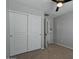 Well-lit bedroom featuring double door closet and carpet at 12838 N 148Th Ln, Surprise, AZ 85379