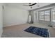 Bright bedroom with bay window, ceiling fan, and area rug at 12838 N 148Th Ln, Surprise, AZ 85379