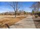 A paved pathway winds through a neighborhood park with mature trees at 12838 N 148Th Ln, Surprise, AZ 85379