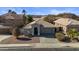 A single story home with arched entryway and desert landscaping at 12838 N 148Th Ln, Surprise, AZ 85379