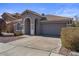 Single-story home with a two-car garage and desert landscaping at 12838 N 148Th Ln, Surprise, AZ 85379