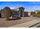 Single story home with a two-car garage and desert landscaping at 12838 N 148Th Ln, Surprise, AZ 85379