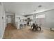 Modern kitchen with white cabinets, island, and dining area at 12838 N 148Th Ln, Surprise, AZ 85379