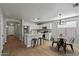 Modern kitchen with white cabinets, island, and dining area at 12838 N 148Th Ln, Surprise, AZ 85379