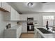 Modern kitchen with white cabinets, stainless steel appliances at 12838 N 148Th Ln, Surprise, AZ 85379