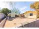 View of the spacious backyard with a storage shed and mature trees, enclosed by block fencing at 14019 N 51St Dr, Glendale, AZ 85306