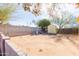 Spacious backyard featuring block fencing, dirt landscaping, and a storage shed at 14019 N 51St Dr, Glendale, AZ 85306