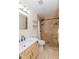 This bathroom features a custom tiled shower with pebble floor accents and built-in shelving at 14019 N 51St Dr, Glendale, AZ 85306