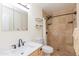 Bathroom showcasing a vanity with a marble countertop and a custom tiled shower at 14019 N 51St Dr, Glendale, AZ 85306