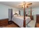 Spacious bedroom featuring a four-poster bed, wood floors, and a mirrored closet at 14019 N 51St Dr, Glendale, AZ 85306