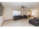 Spacious living room is furnished with leather seating and a large window at 14019 N 51St Dr, Glendale, AZ 85306