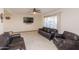 Living room features stylish leather seating and a ceiling fan at 14019 N 51St Dr, Glendale, AZ 85306