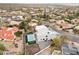 Aerial view showcasing a contemporary house, pool, and neighborhood setting at 15008 N Tamarack Ln, Fountain Hills, AZ 85268