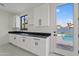 Butler's pantry with pool view, white cabinets, and dark countertops at 15008 N Tamarack Ln, Fountain Hills, AZ 85268