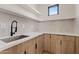 Bright laundry room with modern cabinetry and a clean, functional design at 15008 N Tamarack Ln, Fountain Hills, AZ 85268