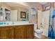 Bathroom with tub, shower, and wood vanity at 15138 W Fillmore St, Goodyear, AZ 85338