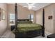 Bedroom with a large four-poster bed and hardwood floors at 15138 W Fillmore St, Goodyear, AZ 85338