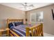 Bedroom with log bed frame and ceiling fan at 15138 W Fillmore St, Goodyear, AZ 85338