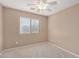 Bright bedroom with ceiling fan and carpeted floor at 15138 W Fillmore St, Goodyear, AZ 85338