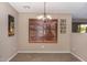 Bright dining area with large window and decorative wall art at 15138 W Fillmore St, Goodyear, AZ 85338