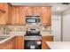 Kitchen features stainless steel appliances and wood cabinets at 15138 W Fillmore St, Goodyear, AZ 85338