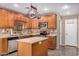 Spacious kitchen with island, stainless steel appliances, and wood cabinets at 15138 W Fillmore St, Goodyear, AZ 85338