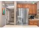 Kitchen features stainless steel refrigerator and wood cabinets at 15138 W Fillmore St, Goodyear, AZ 85338