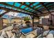 Covered patio with pergola, comfortable seating, and outdoor bar at 15138 W Fillmore St, Goodyear, AZ 85338