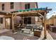 Relaxing patio area with pergola, seating, and outdoor bar at 15138 W Fillmore St, Goodyear, AZ 85338