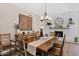 Bright dining room with rustic wooden table and chairs, fireplace, and large wall art at 15429 E Palomino Blvd, Fountain Hills, AZ 85268